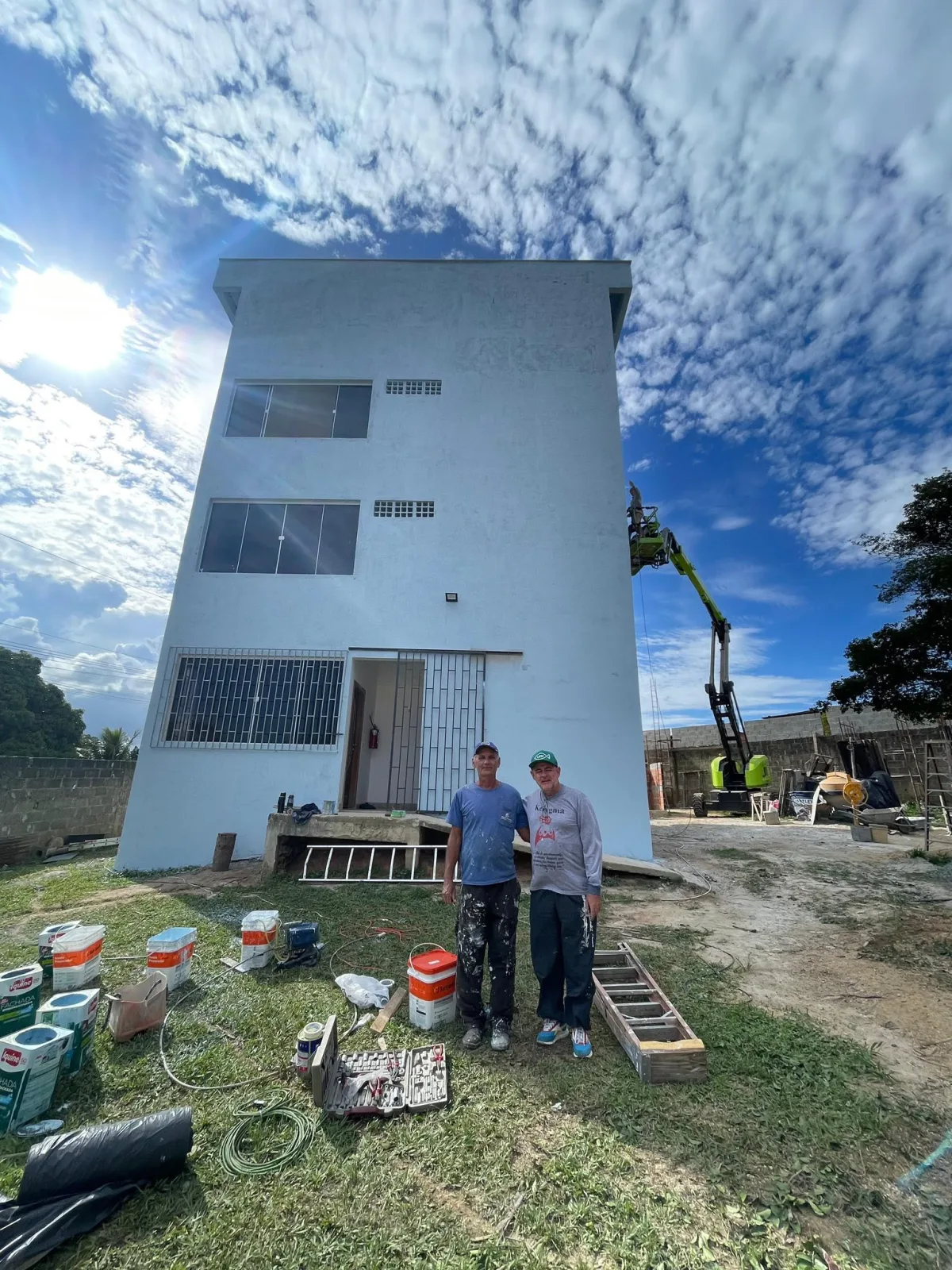 Two members of the renovation team standing in front of MIRC Brasil's renewed ministry base